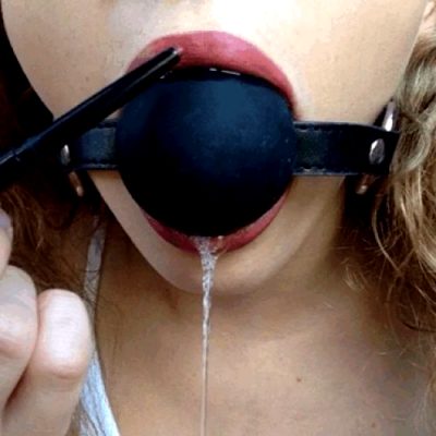 cute painting her lips while being gagged with a big gagball